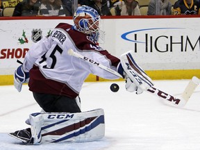Colorado Avalanche goalie Jonathan Bernier blocks a shot during the second of an NHL hockey game against the Pittsburgh Penguins in Pittsburgh, Monday, Dec. 11, 2017.