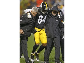 Pittsburgh Steelers wide receiver Antonio Brown (84) is helped off the field after being injured during the first half of an NFL football game against the New England Patriots in Pittsburgh, Sunday, Dec. 17, 2017.