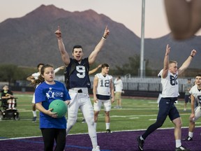 Penn State quarterback Trace McSorley celebrates a catch by Olivia Baumgardner, 10 of Arcadia, Calif., during a charity kickball event with the Children's Cancer Network and HopeKids on Wednesday, Dec. 27, 2017, in Scottsdale, Ariz. Penn State plays Washington in the Fiesta Bowl on Saturday.