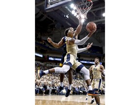 Pittsburgh's Shamiel Stevenson (23) shoots in front of West Virginia's Sagaba Konate (50) during the first half of an NCAA college basketball game Saturday, Dec. 9, 2017, in Pittsburgh.