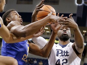 Pittsburgh's Peace Ilegomah (42) and McNeese State's Stephen Ugochukwu battle for a rebound in the first half of an NCAA college basketball game, Saturday, Dec. 16, 2017, in Pittsburgh.
