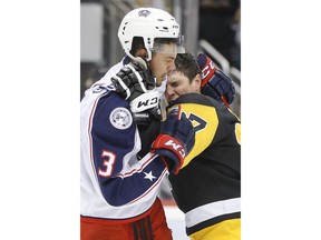 Pittsburgh Penguins' Sidney Crosby, right, and Columbus Blue Jackets' Seth Jones fight during the second period of an NHL hockey game Thursday, Dec. 21, 2017, in Pittsburgh.