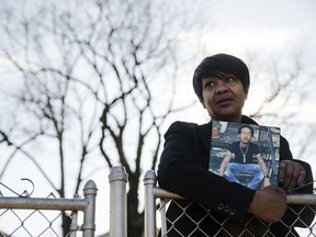 In this Thursday, Dec. 21, 2017 photo, Trina Singleton poses for a photograph in Collingdale, Pa., with a photograph of her eldest son Darryl who was murdered. The Philadelphia Obituary Project, a new website, is working to show that homicide victims in Philadelphia are more than statistics. Trina Singleton said sharing Darryl's life story with the obituary project has helped the family move forward, "so his life isn't summed up by some gunshots."