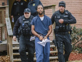 Rahmael Holt, a suspect in New Kensington Officer Brian Shaw's death, is lead from Magisterial District Judge Frank J. Pallone Jr.'s office on Wednesday, Dec. 13, 2017, in New Kensington, Pa. The 29-year-old Natrona Heights man was ordered to stand trial after a preliminary hearing.