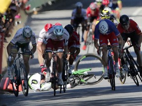 FILE - In this July 4, 2017 file photo, Peter Sagan of Slovakia, left, sprints as Britain's Mark Cavendish crashes, during the sprint of the fourth stage of the Tour de France cycling race in Vittel, France. The UCI ruled Tuesday Dec.5, 2017 that Peter Sagan did not intentionally elbow Mark Cavendish during a sprint finish at the Tour de France in a crash that led to the Slovak rider's disqualification.