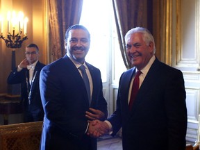 Lebanon's Prime Minister Saad Hariri, left, shakes hands with U.S. Secretary of State Rex Tillerson gathering of world diplomats in Paris, Friday, Dec. 8, 2017. It's the first major gathering of key nations to discuss Lebanon's future since a crisis erupted following Hariri's resignation while in Saudi Arabia.