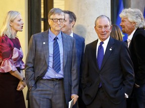 Microsoft co-founder Bill Gates, center, Sir Richard Branson, right, and special envoy to the U.N. for climate change Michael Bloomberg, second right, arrive for a meeting of philanthropists funding climate projects as part of the Climate Summit, at the Elysee Palace, in Paris, Tuesday, Dec. 12, 2017. More than 50 world leaders are gathering in Paris for a summit that Macron hopes will give new momentum to the fight against global warming, despite U.S. President Donald Trump's rejection of the Paris climate accord.