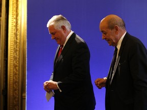 U.S. Secretary of State Rex Tillerson, left, and French Foreign Minister Jean-Yves le Drian leave at a summit convened by France to bolster Lebanon's institutions as it emerges from a bizarre political crisis with regional and international implications. in Paris, Friday, Dec. 8, 2017. It's the first major gathering of key nations to discuss Lebanon's future since a crisis erupted following Hariri's resignation while in Saudi Arabia.
