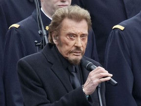 FILE - In this Jan. 10 2016 file photo, French rock star Johnny Hallyday sings during a ceremony to honor the victims of the Islamic extremist attacks at Place de la Republique in Paris. The French president's office says Hallyday, who packed sports stadiums for decades, has died at age 74.