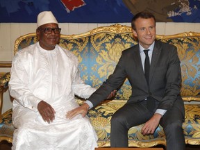 FILE - In this photo dated Tuesday, Oct. 31, 2017 the President of Mali, Ibrahim Boubacar Keita, left, sits with French President Emmanuel Macron before talks at the Elysee Palace in Paris. President Francois Macron is convening presidents, princes and diplomats on Wednesday to breath life into a young African military force with a mission to counter the growing threat jihadi threat in the Sahel region but which is struggling to come alive.