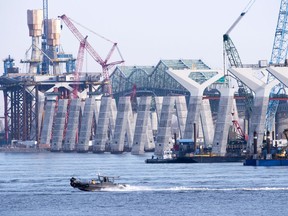 Construction of the new Champlain bridge goes with the old bridge seen in the background on Monday, December 4, 2017 in Montreal. Work is expected to be completed by the end on next year.