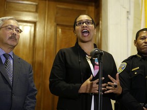 FILE- In this Aug. 15, 2017, file photo, Board of Supervisors President London Breed, center, gestures during a news conference as San Francisco Mayor Ed Lee, left, and police chief William Scott listen at City Hall in San Francisco. Breed became acting mayor in the wake of Lee's sudden death early Tuesday morning, Dec. 12, 2017. The 11-member Board of Supervisors will select a new mayor.