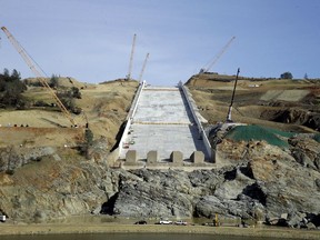 FILE - In this Nov. 30, 2017, file photo, work continues on the Oroville Dam spillway in Oroville, Calif. California water officials plan to update a Northern California community about their efforts to repair the nation's tallest dam after damage to its spillways forced nearly 200,000 people to evacuate last February.