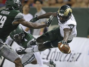 FILE - This Sept. 30, 2017, file photo shows Hawaii defensive backs Trayvon Henderson (39) and Daniel Lewis Jr. (4), defending Colorado State wide receiver Michael Gallup (4) who tries to leap into the end zone during the second quarter of the NCAA college football in Honolulu. Colorado State and Marshall, two programs that started strong only to end finish slow this season, are meeting in the New Mexico Bowl to help kick off the college postseason.