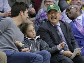 FILE - In this Jan. 6, 2017, file photo, San Francisco Mayor Ed Lee, second from right, laughs as he talks with Golden State Warriors general manager Bob Myers, left, during the first half of an NCAA college basketball game between San Francisco and Gonzaga in San Francisco. Hundreds of people are expected for a public celebration in San Francisco Sunday, Dec. 17, 2017, of the life of Lee, who died suddenly Tuesday, Dec. 12, 2017. Lee, 65, was San Francisco's first Asian-American mayor and a former civil rights lawyer who led the city out of recession and into a dazzling economic recovery that has not benefited everyone.
