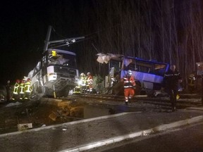 In this photo provided by France Bleu, rescue workers help after a school bus and a regional train collided in the village of Millas, southern France, Thursday, Dec. 14, 2017. A school bus and a regional train collided in southern France on Thursday, killing four children and critically injuring several other people on the bus, the French interior ministry said.