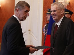Billionaire and leader of ANO 2011 political movement Andrej Babis, left, is sworn in as the country's new prime minister by Czech Republic's President Milos Zeman in Prague, Czech Republic, Wednesday, Dec. 6, 2017.