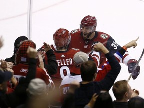 Arizona Coyotes center Clayton Keller, middle, celebrates his overtime against the Washington Capitals with defenseman Alex Goligoski (33) in an NHL hockey game, Friday, Dec. 22, 2017, in Glendale, Ariz. The Coyotes defeated the Capitals 3-2.