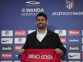Diego Costa holds up his new shirt during his official presentation for Atletico Madrid at the Wanda Metropolitano stadium in Madrid, Spain, Sunday, Dec. 31, 2017. Costa was signed from Chelsea earlier in 2017 but was not eligible to play until 2018.