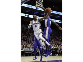 Sacramento Kings' Garrett Temple, left, goes up for a shot against Philadelphia 76ers' Amir Johnson during the first half of an NBA basketball game, Tuesday, Dec. 19, 2017, in Philadelphia.