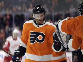Philadelphia Flyers' Sean Couturier celebrates with his teammates after scoring during the third period of an NHL hockey game against the Detroit Red Wings, Wednesday, Dec. 20, 2017, in Philadelphia. Philadelphia won 4-3.