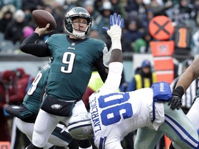 Philadelphia Eagles' Nick Foles (9) passes over Dallas Cowboys' DeMarcus Lawrence (90) during the first half of an NFL football game, Sunday, Dec. 31, 2017, in Philadelphia.
