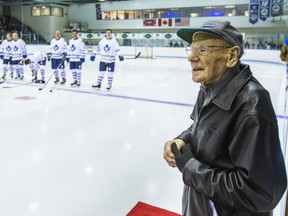 In this Nov. 13, 2014 file photo, Johnny Bower stands on the ice before a Toronto Maple Leafs-Montreal Canadiens alumni charity game in Markham, Ont.