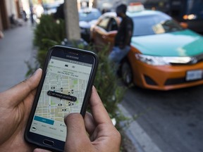 An individual uses the Uber app in Toronto.