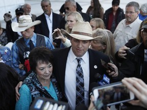 Ammon Bundy, right, and Carol Bundy, wife of Nevada rancher Cliven Bundy, speak with reporters outside of a federal courthouse Wednesday, Dec. 20, 2017, in Las Vegas. Chief U.S. District Judge Gloria Navarro declared a mistrial Wednesday in the case against Cliven Bundy, his sons Ryan and Ammon Bundy and self-styled Montana militia leader Ryan Payne.