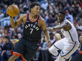 Raptors guard Kyle Lowry looks to pass the ball during second half action against the Brooklyn Nets' Caris LeVert at the Air Canada Centre in Toronto on Friday night.