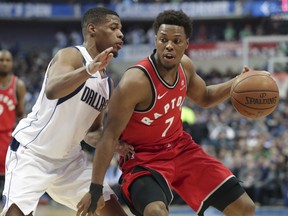 Toronto Raptors guard Kyle Lowry dribbles against the Mavericks' Dennis Smith Jr. during the first half of their game in Dallas on Tuesday night.