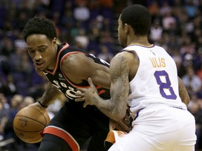 Toronto Raptors guard DeMar DeRozan drives on Suns guard Tyler Ulis in the first quarter of their game Wednesday in Phoenix.