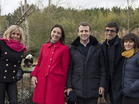 French President Emmanuel Macron, center, his wife Brigitte Macron, left, and zoo managers: Delphine Delord, 2nd right, Sophie Delord, right, and Rodolphe Delord, pose for photographers during a private visit at the Beauval Zoo, in Saint-Aignan-sur-Cher, France. (Zoo de Beauval via AP)