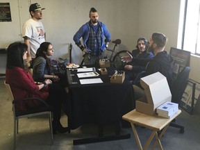 In this Wednesday, Dec. 27, 2017, photo, Estrella Terrones, left, a "budtender" listens to a sales tutorial from one of the marijuana dispensary's suppliers at Golden State Greens marijuana dispensary in San Diego. Dozens of California shops have cleared a final hurdle to sell marijuana for recreational use starting Monday, Jan. 1, 2018, and regulators will work through the weekend to grant more licenses.