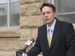 FILE - In this June 16, 2009, file photo, Apache County Attorney Michael Whiting speaks outside the courthouse in St. Johns, Ariz., to reporters about the case where Vincent Romero and Timothy Romans, of San Carlos, Ariz., were found fatally shot. Romero's 8-year-old son, who pleaded guilty to a negligent homicide charge in the 2008 killing, is nearing the end of probation.