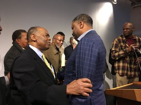 NAACP President Derrick Johnson, right, speaks with Dr. Robert Smith, former president of the Medical Committee for Human Rights, after a speech Saturday, Dec. 9, 2017, denouncing the visit of President Donald Trump in Jackson, Miss., for the opening of twin history and civil rights museums marking Mississippi's bicentennial.