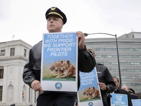 About 350 pilots, including a handful from other airlines, stage an informational picket outside Denver's city hall in Denver, Colo., Thursday, Dec. 7, 2017. The pilots are trying to win support from the public as they push for higher pay from Denver-based discount carrier, Frontier Airlines.