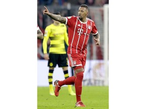Bayern's Jerome Boateng celebrates after scoring the opening goal during the round of sixteen German soccer cup match between FC Bayern Munich and Borussia Dortmund in Munich, Germany, Wednesday, Dec. 20, 2017.