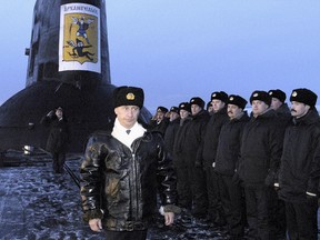 In this file photo taken on Tuesday, Feb. 17, 2004, Russian President Vladimir Putin thanks the crew of the Arkhangelsk nuclear submarine in the Barents Sea, Russia.