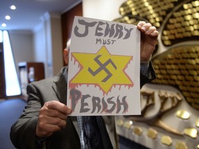 A piece of hate mail is held at a synagogue in Montreal on Tuesday Dec. 19, 2017.