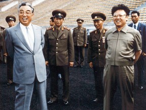 A photo taken in 1992 shows Kim Jong-Il, right, and then-leader, Jong-il's father, Kim Il-Sung.