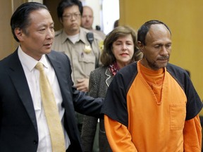 In this July 7, 2015 file photo, Jose Ines Garcia Zarate, right, is led into the courtroom by San Francisco Public Defender Jeff Adachi, left, and Assistant District Attorney Diana Garciaor, center.