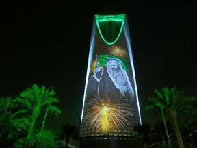 In this file photo taken onIn this Sunday, Sept. 24, 2017 photo released by the Saudi Culture and Information Ministry, the image of King Salman and Crown Prince Mohammed bin Salman are projected on the Kingdom Tower during National Day ceremonies in Riyadh, Saudi Arabia.