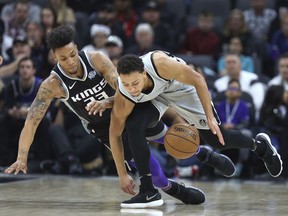 Sacramento Kings guard Malachi Richardson (23) and San Antonio Spurs guard Bryn Forbes (11 )go after a loose ball during the first half of an NBA basketball game in Sacramento, Calif., Saturday, Dec 23, 2017.
