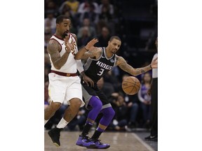 Cleveland Cavaliers guard J.R. Smith, left, and Sacramento Kings guard George Hill chase after the ball as it goes out of bounds during the first quarter of an NBA basketball game, Wednesday, Dec. 27, 2017, in Sacramento, Calif.
