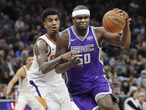Sacramento Kings forward Zach Randolph (50) drives to the basket around Phoenix Suns forward Marquese Chriss (0) during the first half of an NBA basketball game in Sacramento, Calif., Friday, Dec. 29, 2017.