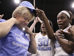 North Carolina coach Sylvia Hatchell is greeted by her players after their 79-63 win over Grambling State in an NCAA college basketball game in the Crescom Bank Holiday Invitational tournament, Tuesday, Dec. 19, 2017, at the Myrtle Beach Convention Center in Myrtle Beach, S.C. Hatchell, who battled leukemia and was declared cancer-free in 2014, earned her 1,00th career coaching victory with the win.
