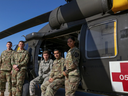 From Left: Chief Warrant Officer 2 Nathan Gumm; Chief Warrant Officer 2 Eric Tirro; Spc. Carroll Moore; Sgt. 1st Class Gopal Singh; and Pfc. Karina Lopez, all of the Eighth Army's 2nd Combat Aviation Brigade, pose for a photo with a Black Hawk at Camp Humphreys, South Korea. 
