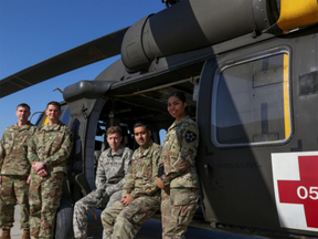 From Left: Chief Warrant Officer 2 Nathan Gumm; Chief Warrant Officer 2 Eric Tirro; Spc. Carroll Moore; Sgt. 1st Class Gopal Singh; and Pfc. Karina Lopez, all of the Eighth Army's 2nd Combat Aviation Brigade, pose for a photo with a Black Hawk at Camp Humphreys, South Korea.