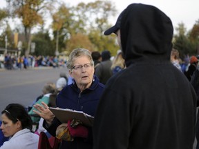 In this Oct. 14, 2017 photo, Joyce Scott, left, seeks signatures for a proposed South Dakota government ethics constitutional amendment in Brookings, S.D. The amendment would stop lawmakers from changing future ballot measures and the state's initiative system without taking the changes to a public vote.